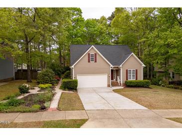 Charming single Gathering home featuring a 1-car garage, landscaped yard, and neutral exterior with red shutters at 216 Harvester Dr, Holly Springs, NC 27540