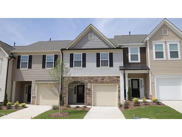 Charming townhome exterior featuring stone accents, siding, and attached garages at 3007 Cypress Lagoon Ct, Durham, NC 27703