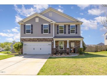Charming two-story home with gray siding, stone accents, black shutters, and a well-manicured front yard at 411 Lawton Dr, Haw River, NC 27258