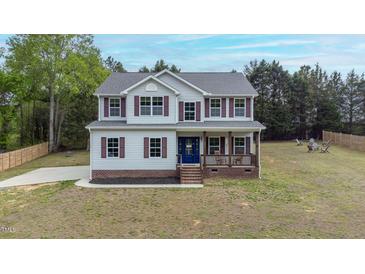 Charming two-story home with covered front porch and well-maintained lawn at 4228 Nc 42 Hwy, Raleigh, NC 27603