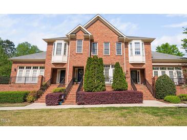 Charming two-story brick home featuring a well-manicured lawn and appealing front entryway at 608 Derby Ct, Durham, NC 27707