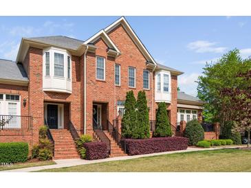 Charming brick home with manicured landscaping and welcoming entrance stairs and wrought iron handrails at 608 Derby Ct, Durham, NC 27707