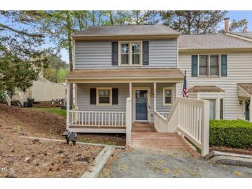 Charming home featuring a welcoming front porch, neutral siding, and well-maintained landscaping at 6568 English Oaks Dr, Raleigh, NC 27615