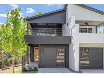 This is a modern two-story home with a two-car garage and a second-story balcony at 732 Hopkins St, Durham, NC 27701