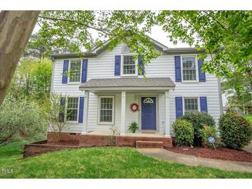 Charming two-story home featuring a welcoming front porch and blue shutters at 104 Dilworth Ct, Cary, NC 27513