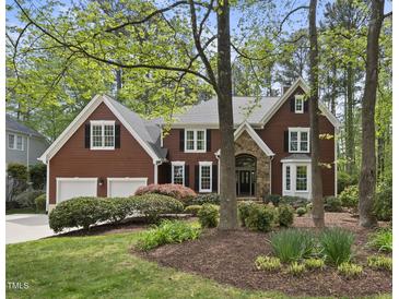Charming two-story home with a well-manicured lawn, mature trees, and a two-car garage at 109 Deer Valley Dr, Cary, NC 27519