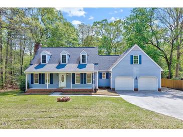 Charming two-story home with a well-manicured lawn and a welcoming two-car garage at 1433 Andersonwood Dr, Fuquay Varina, NC 27526