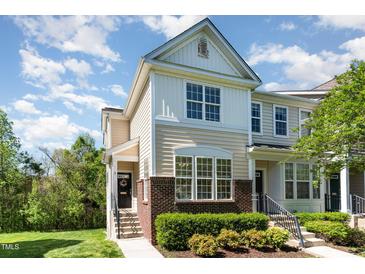 Charming two-story townhome with manicured landscaping and inviting entrance, showcasing the home's curb appeal at 162 Grey Elm Trl, Durham, NC 27713
