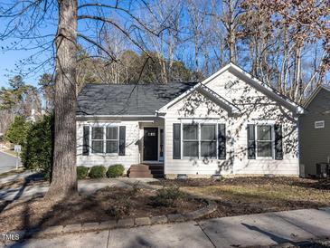 Charming single-story home showcasing a well-maintained lawn and inviting curb appeal with a black door and black shutters at 211 Milky Way Dr, Apex, NC 27502