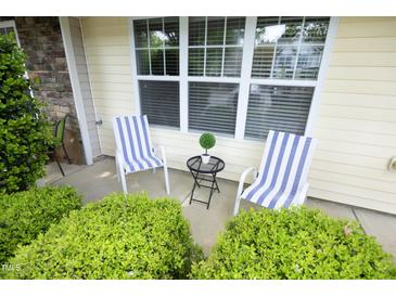 Inviting front porch with striped chairs and garden view at 3623 Bison Hill Ln, Raleigh, NC 27604