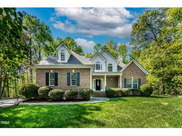 Charming brick home with a manicured lawn and lush landscaping at 40 Holden Ct, Youngsville, NC 27596
