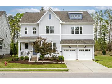 Charming two-story home with grey siding, a two-car garage and a well-manicured lawn at 490 Boulder Point Dr, Chapel Hill, NC 27516