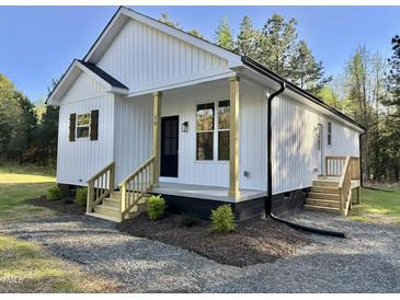 Charming single Gathering home featuring board and batten siding and a welcoming front porch at 50 Lakewood Dr, Roxboro, NC 27573