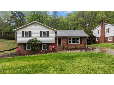 Charming two-story home with brick facade, manicured lawn, and mature trees in a desirable neighborhood at 505 Forest Road Rd, Oxford, NC 27565