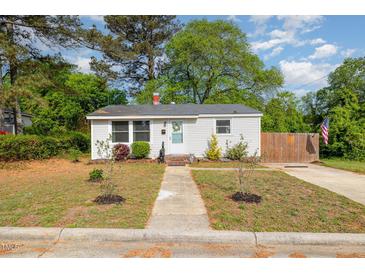 Charming single-story home with a manicured front yard and a welcoming entrance at 509 N Elm St, Benson, NC 27504