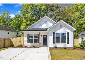 Charming new construction home with white siding, black shutters, and well-manicured lawn at 617 Ray St, Selma, NC 27576
