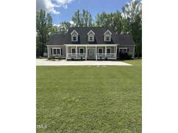 Charming home with a full front porch, dormer windows and mature trees surrounding at 6283 Harrisontown Rd, Rocky Mount, NC 27804