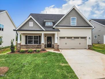 Charming single-Gathering home with a two-car garage and manicured lawn in a desirable neighborhood at 1075 Fairhaven Dr # 51, Mebane, NC 27302