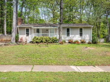 Charming single-story home with a cozy front porch and mature landscaping at 1312 Rothes Rd, Cary, NC 27511