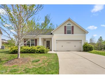 Charming single-Gathering home with a well-maintained lawn, attached two-car garage, and a lovely front porch at 223 Triumph Dr, Elon, NC 27244