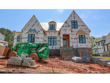 Two-story home under construction, featuring brick base, windows, and a partially installed roof at 2328 Ballywater Lea Way, Wake Forest, NC 27587