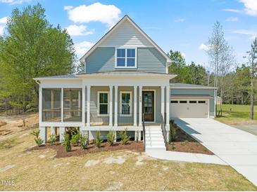 Charming two-story home with a welcoming front porch and well-manicured landscaping, offering curb appeal at 250 Pilot Ridge Rd, Zebulon, NC 27597