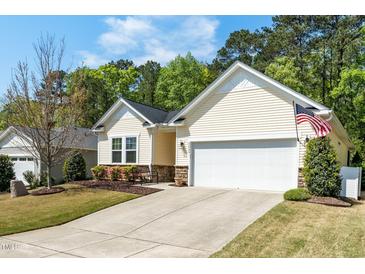 Charming single Gathering home with manicured lawn, 2-car garage, and tasteful landscaping at 3029 Willow Ranch Dr, Fuquay Varina, NC 27526