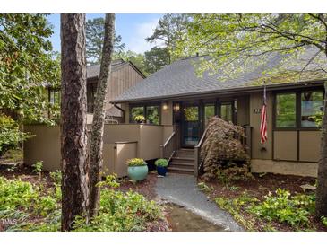 Inviting home with a charming walkway, landscaped garden, and classic architectural details at 33 Stoneridge Cir, Durham, NC 27705