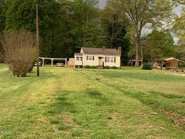 Quaint single Gathering home with covered parking and well-maintained lawn and natural surroundings at 335 Ashley Ave, Timberlake, NC 27583