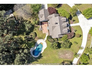 Stunning aerial view of the house with a beautiful backyard and an inviting blue swimming pool at 40 Farrells Creek Rd, Apex, NC 27523