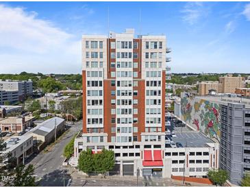 Modern high-rise building with red-brick accents and parking garage in a vibrant urban neighborhood at 400 W North St # 1420, Raleigh, NC 27603