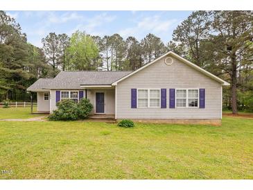 Charming single-story home featuring a well-manicured lawn and classic purple shutters at 545 Irvan St, Clayton, NC 27520