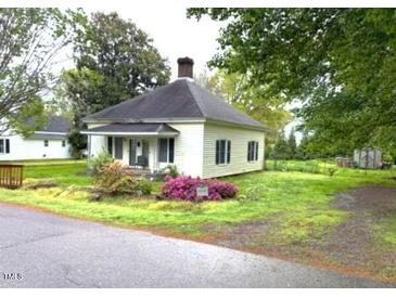 Charming single-story home with a cozy front porch and mature trees in a quiet neighborhood at 702 Mill St, Wake Forest, NC 27587