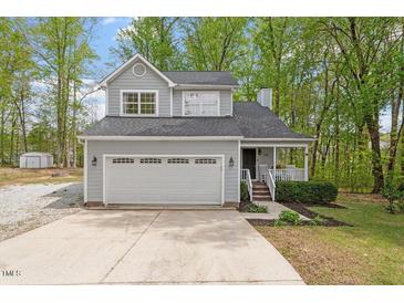 Charming two-story home with a well-maintained front yard, large garage, and inviting front porch at 120 Kerigon Ln, Youngsville, NC 27596