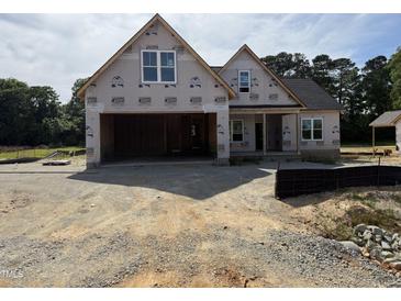 New construction home featuring a two-car garage and partially completed front entrance at 125 Tee Dr, Selma, NC 27576