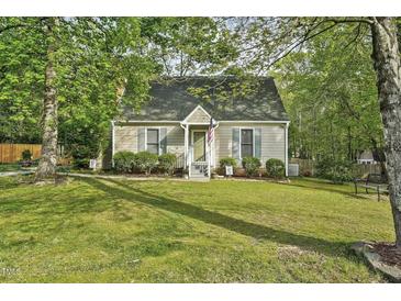 Charming single-story home with a manicured lawn and mature trees at 13816 N Meadows Ct, Wake Forest, NC 27587