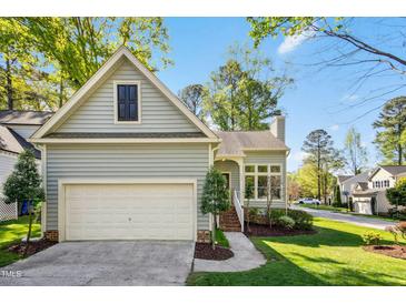 Charming home with a two-car garage and lovely landscaping at 1433 Deltona Dr, Raleigh, NC 27615