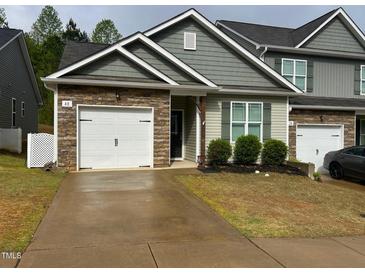 Charming townhome with stone accents, a two-car garage and inviting curb appeal at 48 Cullen Ct, Clayton, NC 27520