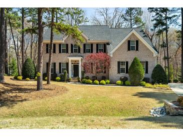 Traditional brick home with manicured lawn and landscaping at 83 Calabria Ct, Clayton, NC 27527