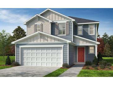 Two-story home showcasing blue siding, white trim, a two-car garage, and a red front door at 952 Emmer St, Rolesville, NC 27571