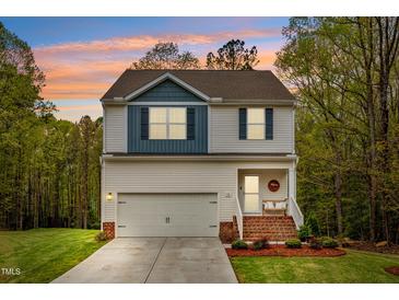 Charming two-story home with a front-facing garage and welcoming front porch at 10 Shearin Ln, Youngsville, NC 27596