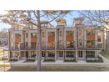 Modern townhome exterior features a brick facade, private balconies, and sleek, contemporary design at 1010 Manor Way, Durham, NC 27701