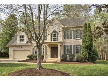 Charming two-story brick home featuring manicured landscaping and a welcoming front entrance at 1335 Saint Andrews Dr, Mebane, NC 27302
