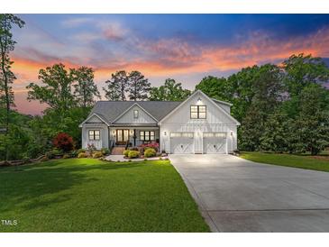 Charming two-story farmhouse with landscaped yard and a three-car garage at 1506 Gormly Cir, Sanford, NC 27330