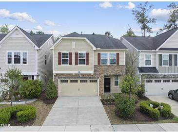 Charming two-story home featuring a stone facade, red shutters, and a well-maintained front yard at 204 Concordia Woods Dr, Morrisville, NC 27560