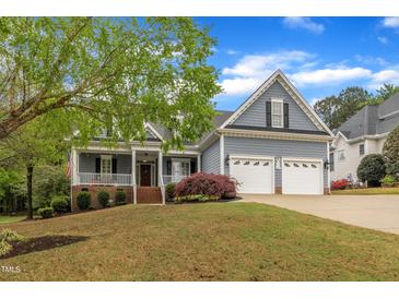 Charming home with a welcoming front porch, attached two-car garage, and well-manicured lawn at 212 Hein Dr, Clayton, NC 27527