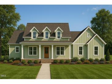 Charming home featuring a covered front porch and a well-manicured lawn at 2600 Banks Rd # 2, Raleigh, NC 27603
