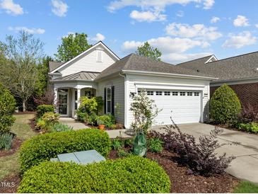 Charming single-story home with a well-manicured lawn, mature landscaping, and an attached two-car garage at 320 Easton Grey Loop, Cary, NC 27519