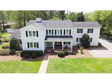 Charming two-story home featuring black shutters, a covered front porch, and a well-manicured lawn at 3609 Hawthorne Rd, Rocky Mount, NC 27804