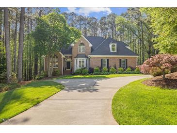 Traditional brick home boasts lush landscaping and a winding driveway at 3928 White Chapel Way, Raleigh, NC 27615